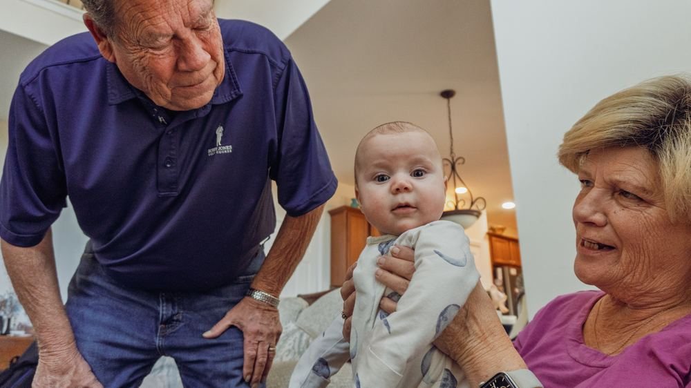Grandparents holding an infant